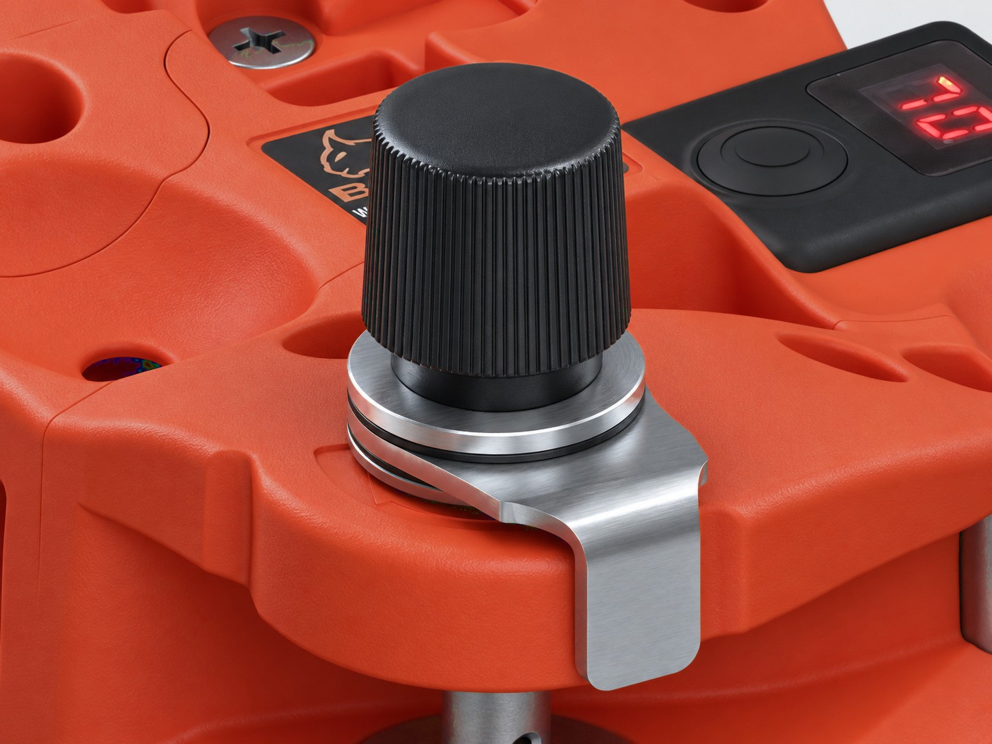 ACT5 mounted on a Bobcat spindle, showing its adjustment knob and metal bracket
