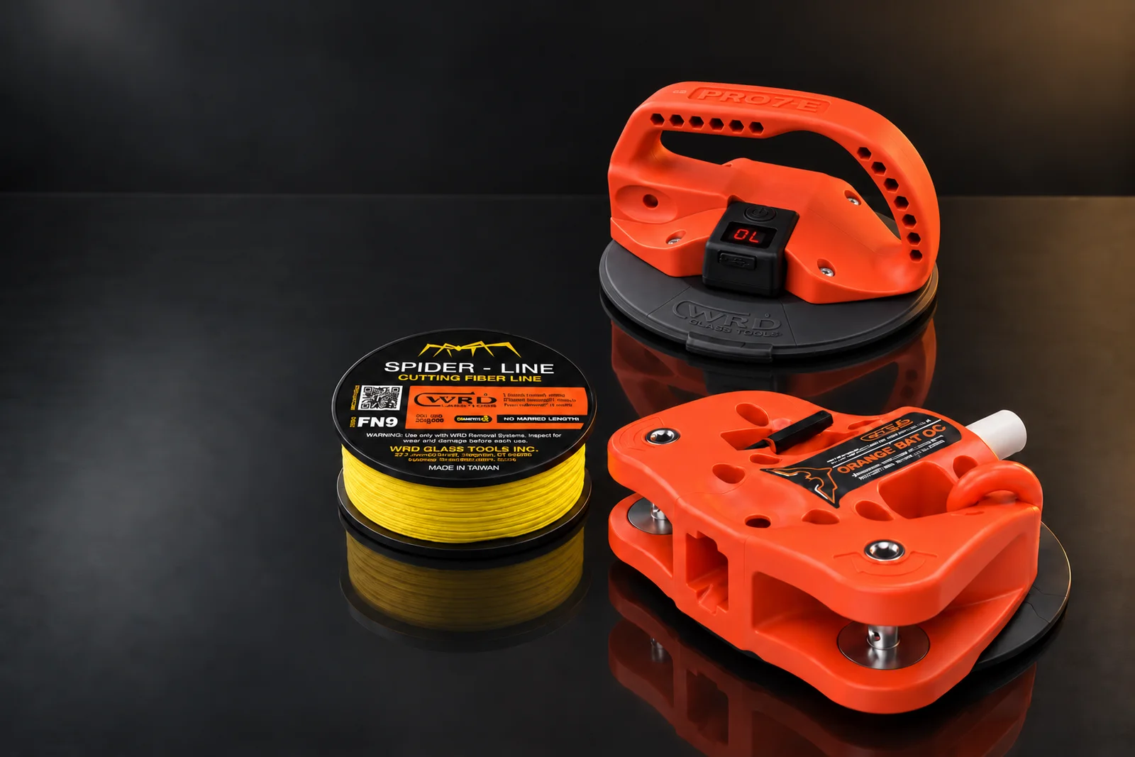 Orange Bat QC removal tool, PRO7E handling cup and FN9 Spider Line spool in a studio arrangement